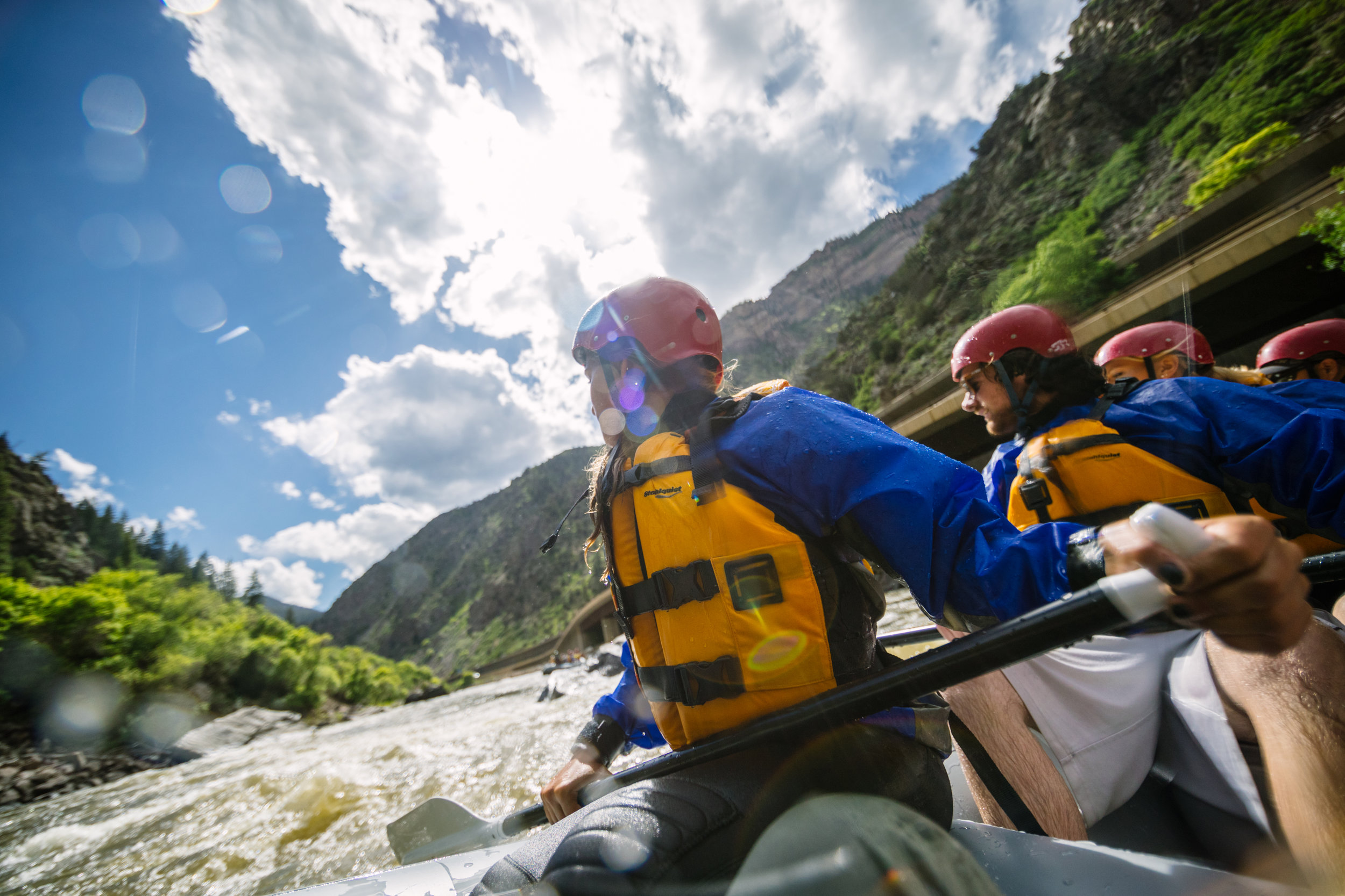 a co whitewater rafting group rafts down a river during the day