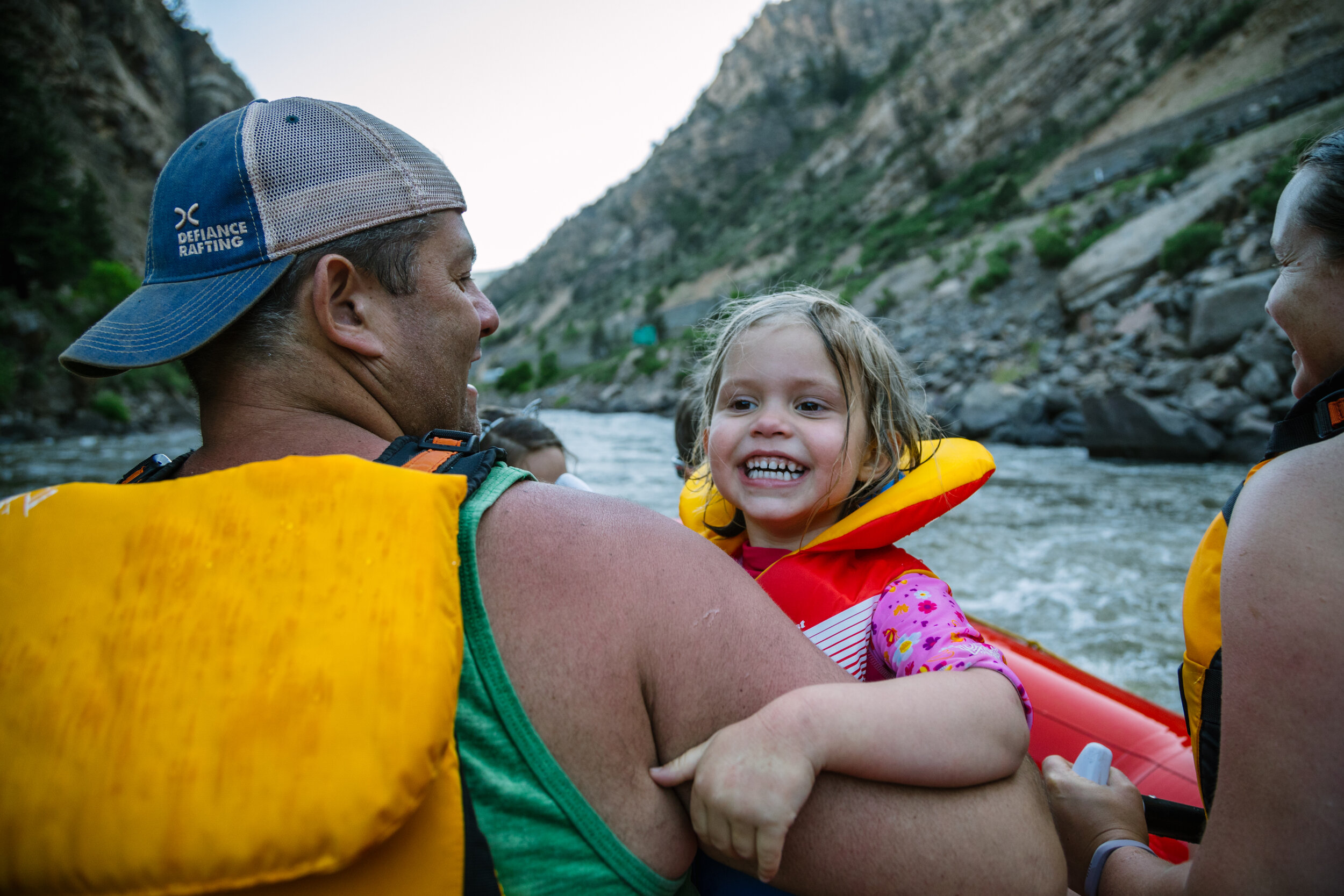little girl smiling during a family whitewater rafting trip