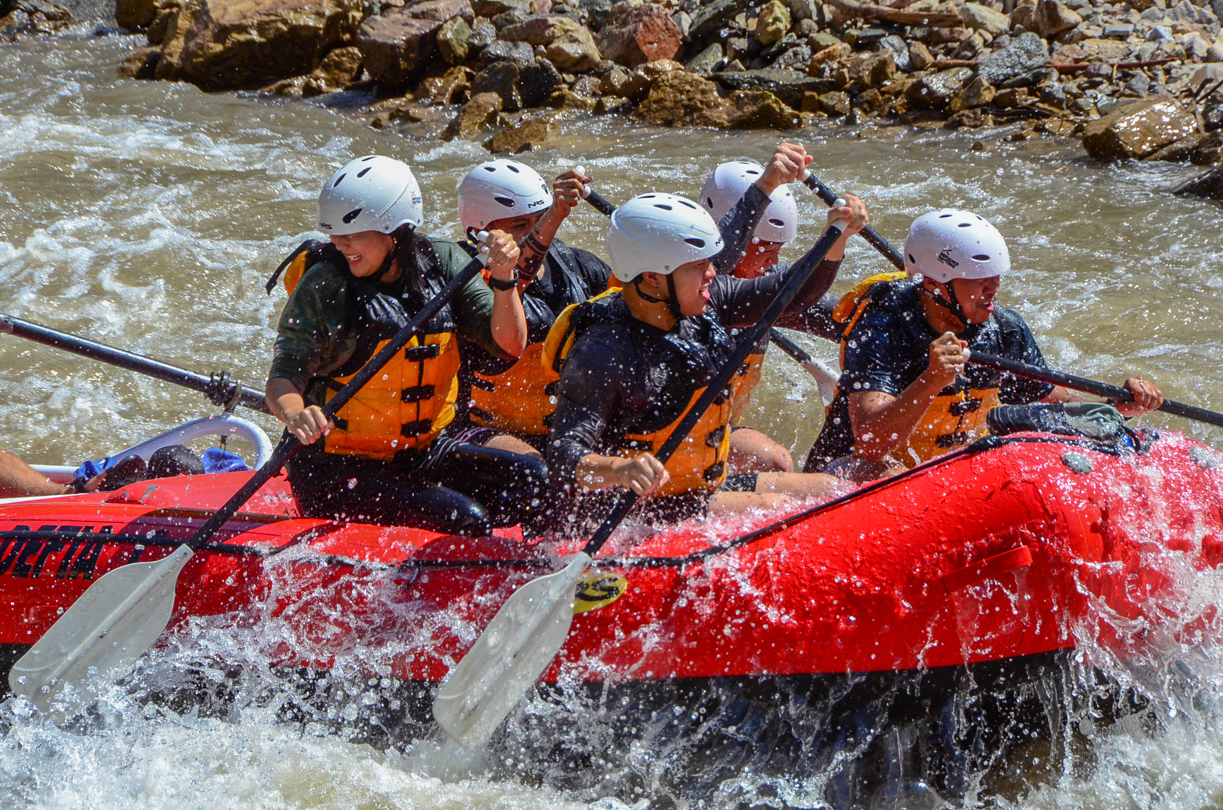 corporate group going down the river rapids